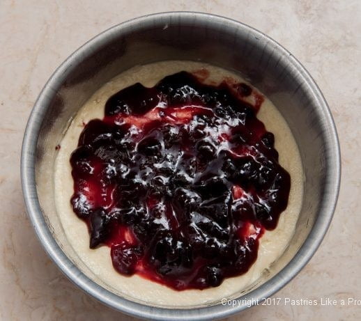 Raspberry jam spread on the bottom layer of Easily Made Raspberry Ripple Coffeecake
