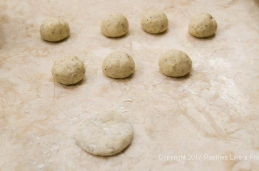 One ball of dough flattened for Garlic oregano Cracker Bread