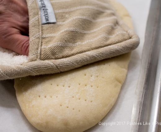 Crusts being flattened for International Flatbreads