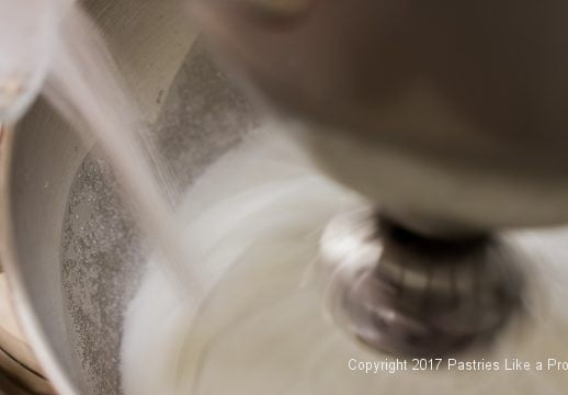 Adding sugar for the Chocolate Raspberry Marzipan Gateau