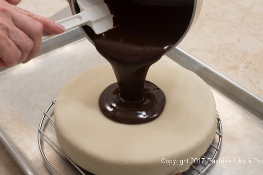 Pouring glaze onto cake for the Chocolate Raspberry Marzipan Gateau