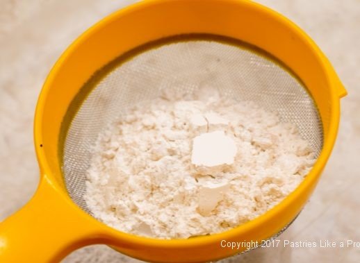 Sifting flour for the Chocolate Raspberry Marzipan Gateau