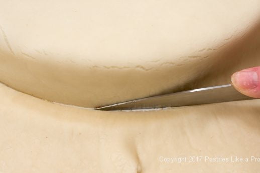 Trimming the bottom of the marzipan for the Chocolate Raspberry Marzipan Gateau