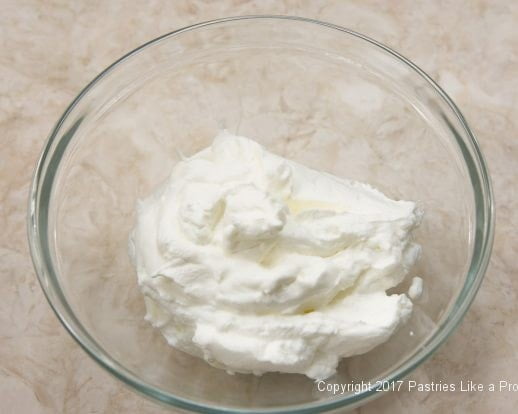 Whipped cream in bowl for the Strawberry Chocolate Crunch Parfaits