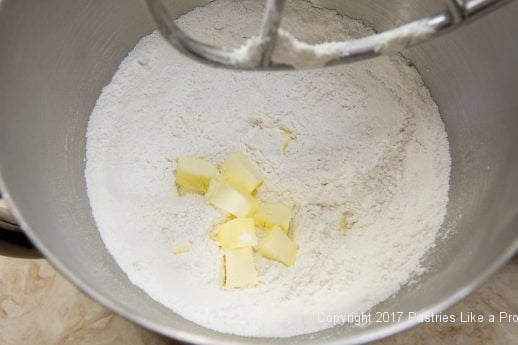 Butter added to flour for Scones with Cranberry and Strawberry Jam