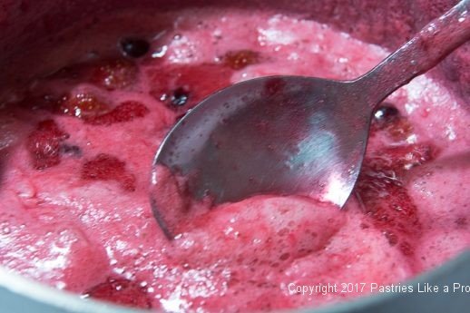 Skinming foam for Scones with Cranberry and Strawberry Jam