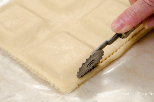 Trimming around the patties for the Peppermint Ravioli Cookies