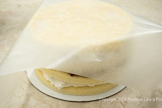 Wax paper on top layer for Raspberries and Cream Cake