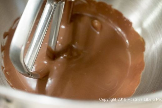 Ganache in mixer bowl with the paddle for Raspberries and Cream Cake