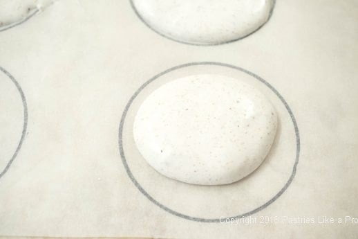 Meringue spooned onto template for Hazelnut Meringue with Raspberry Mascarpone Mousse