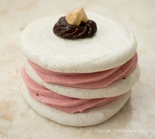 Stacked and finished Hazelnut Meringue with Raspberry Mascarpone Mousse