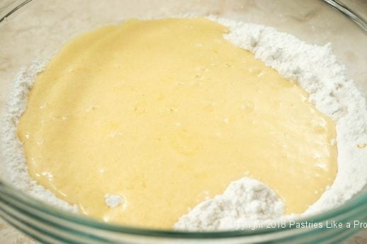 Wet ingredients added to dry for Crumbed Topped Orange Muffins