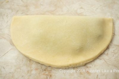 Top of pastry folded over filling for Sweet Cherry Calzones
