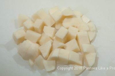 Cut potatoes for Plum Dumplings