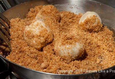 Rolling dumplings in bread crumbs for Plum Dumplings