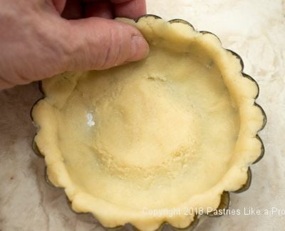 Pressing dough into sides of pan for Browned Butter Tart