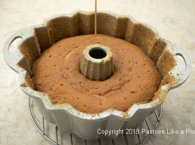 Holes poked in cake for Citrus Pound Cake