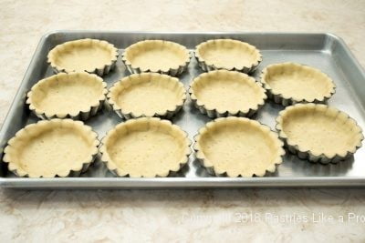 Unbaked tray of tart shells for Browned Butter Tarts