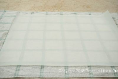 Parchment on towel for Traditional Apple Strudel
