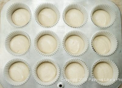 White batter in cups for Malted Milk Frosted Cupcakes, Cupcake Frosting, Cupcake Frosting Recipe, How to frost Cupcakes