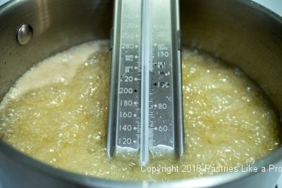 Thermometer in pan for the Salted Macadamia Rum Toffee, Rum Toffee Recipe
