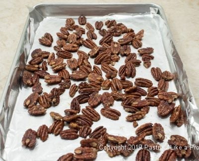 Pecans on baking sheet for Maple Pecans