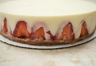 Pastry cream on strawberries for Vanilla Mousse Torte with Strawberries