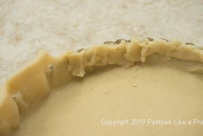 Turning edge of pastry shell in