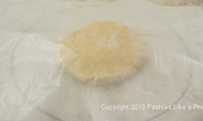 Wax paper covering dough round