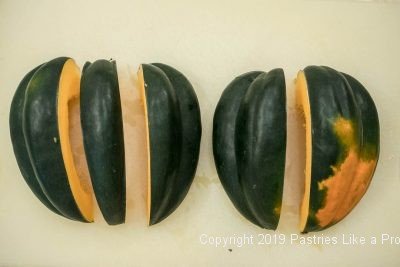 Acorn squash sliced before cleaning