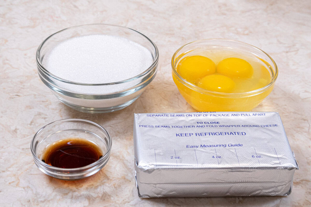Ingredients for the cheesecake layer are cream cheese, vanilla, eggs and granulated sugar.