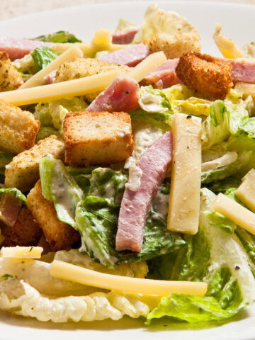 This Mayfair Salad Dressing features, lettuce, swiss cheese and ham strips, croutons and Mayfair dressing.