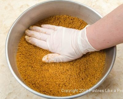 Pressing in crumbs for Pumpkin Mousse Torte