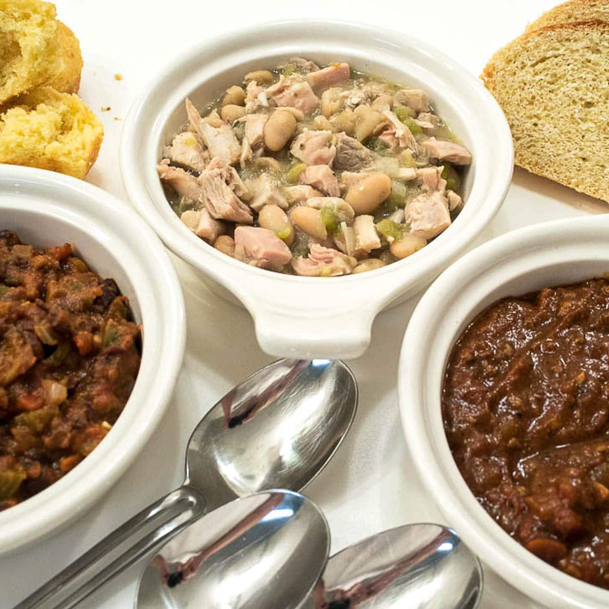 Bowls of Black Bean Chili, White Chicken Chili, Killer Chili with bread