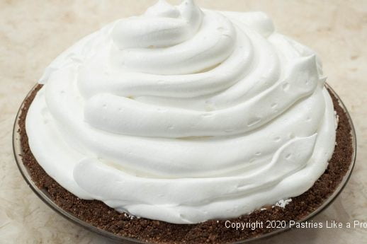 Meringue piped on for Sky High Chocolate Pie