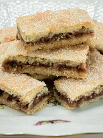 Rugelach Bars are stacked on a decorative plate.