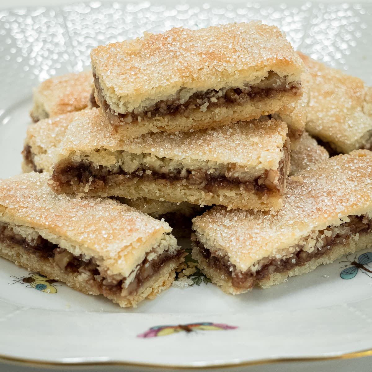 Rugelach Bars are stacked on a decorative plate.