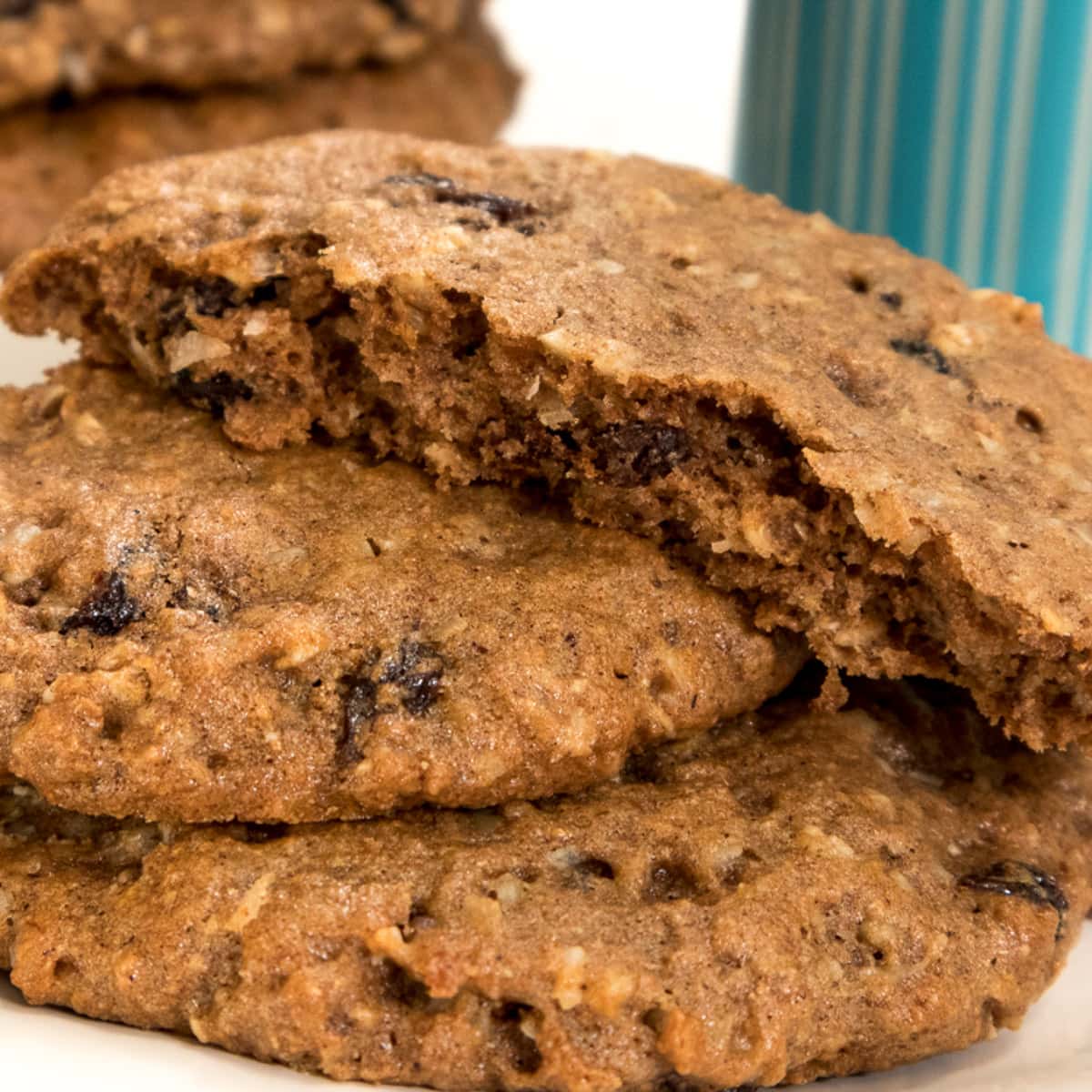 A tray of breakfast cookies with a blue striped glass of milk.