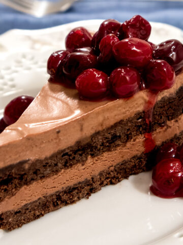 This Riene de Saba cake features 2 layers of chocolate cake with a mousse like filling, topped with candied cranberries