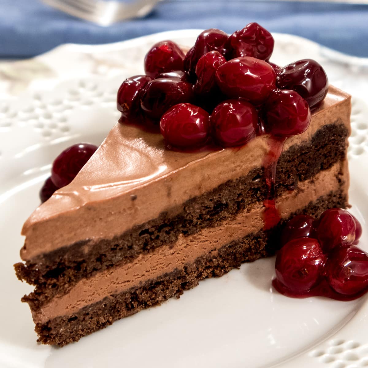 This Riene de Saba cake features 2 layers of chocolate cake with a mousse like filling, topped with candied cranberries