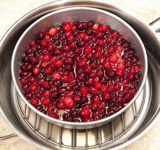 Cranberries in pan with the syrup