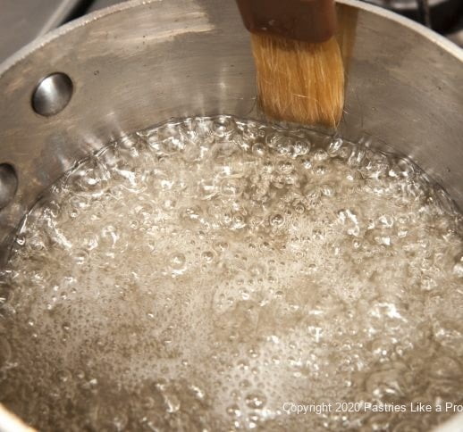 Washing down sides of the pan