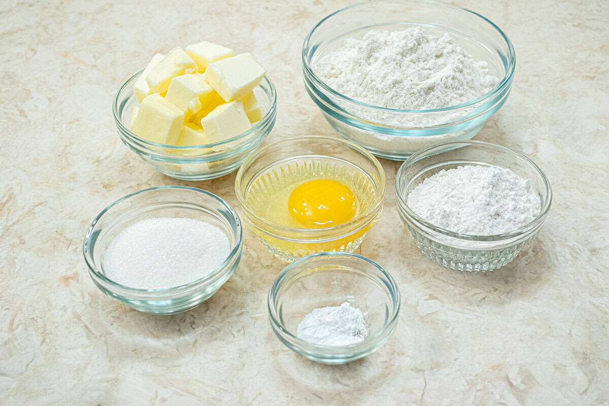 The ingredients for the press in crust include unsalted butter, all-purpose flour, cake flour, baking powder, granulated sugar and an egg. 