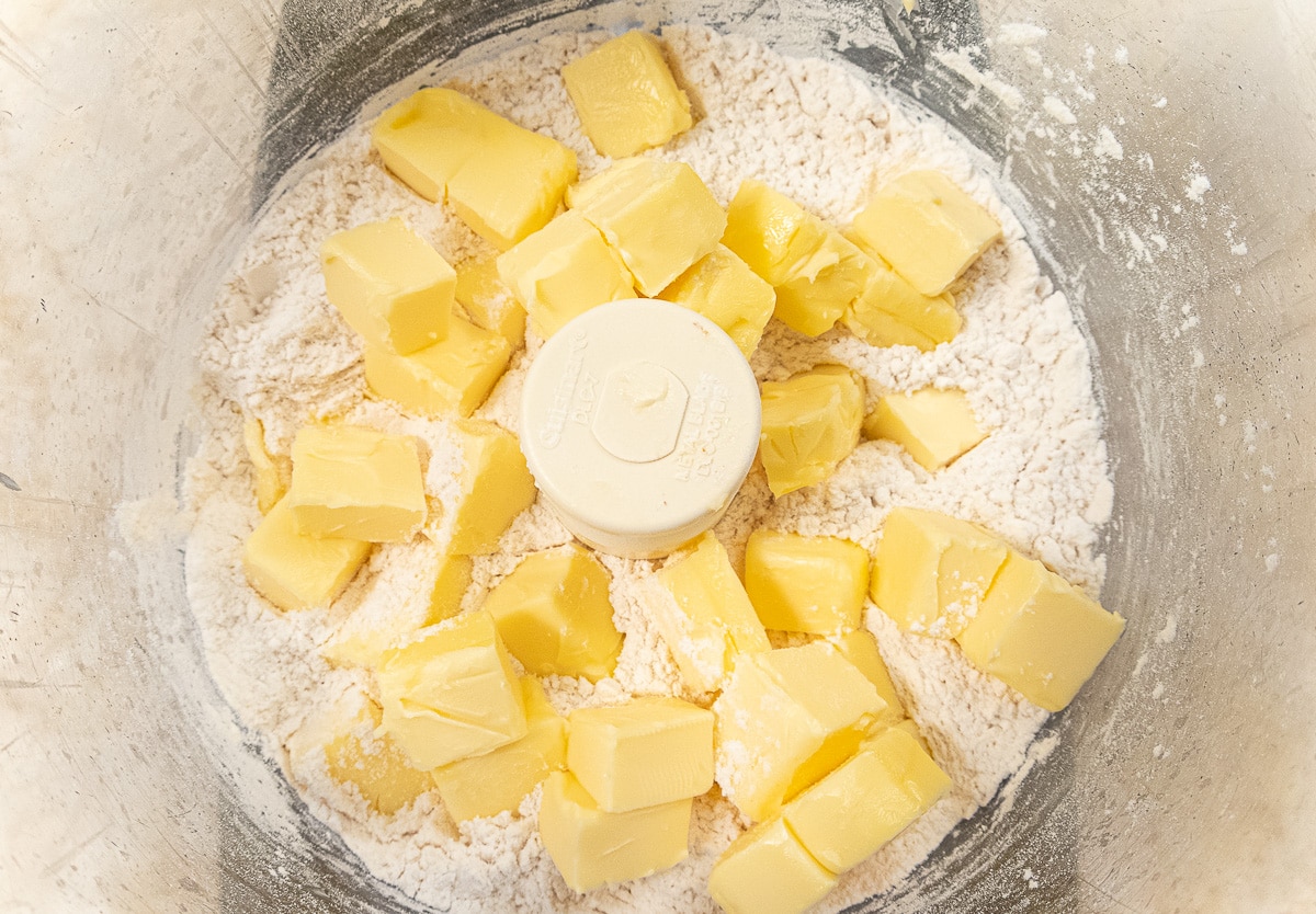 Butter added to flour mixture in processor