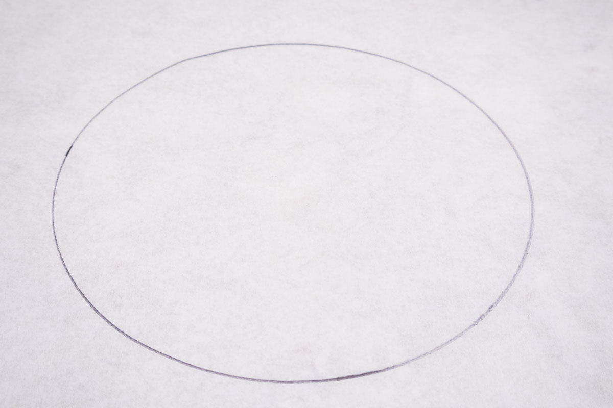 9" circle drawn on a piece of parchment paper