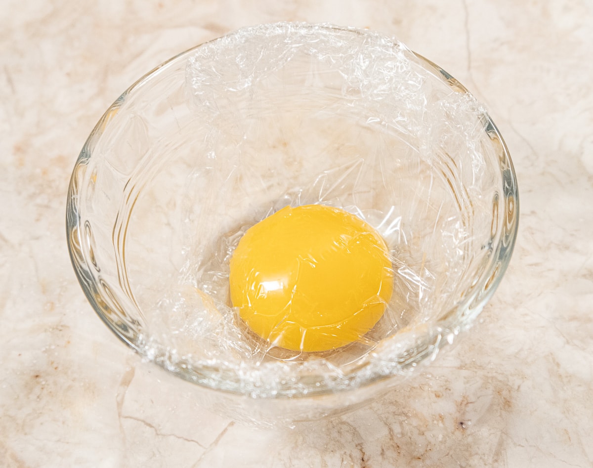 Egg yolk covered with film  and refrigerated until needed