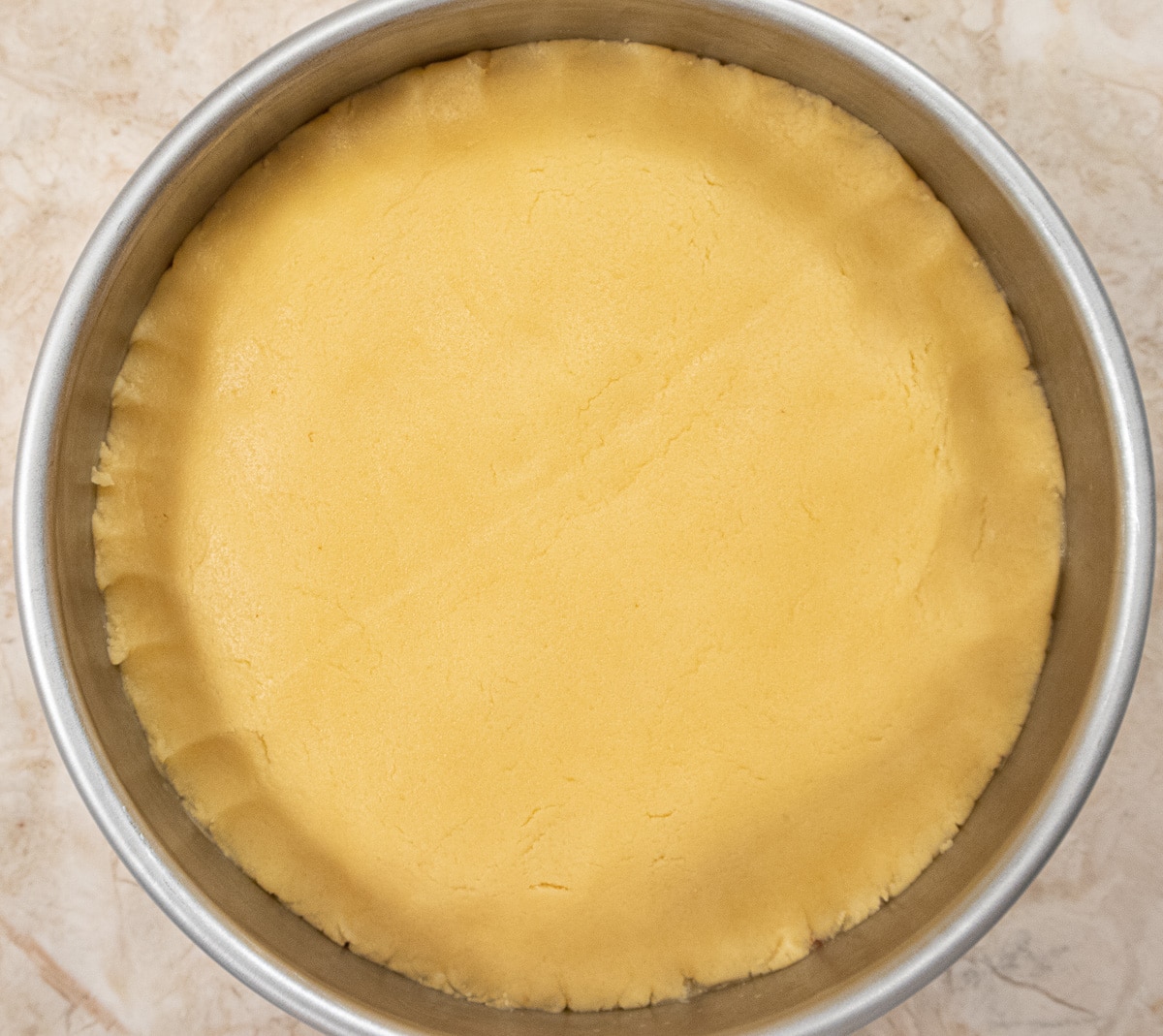 The top crust in place over the filling