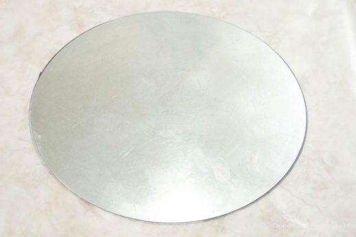The bottom of the tart pan is used to draw a circle onto waxed paper.