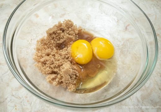 The brown sugar, egg and egg yolk are in a bowl.