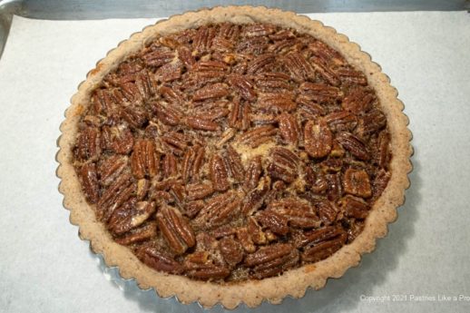 The tart is baked and the pecans have risen to the top.